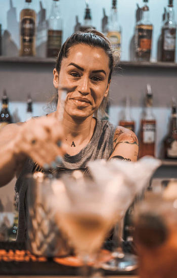 girl stiring a cocktail