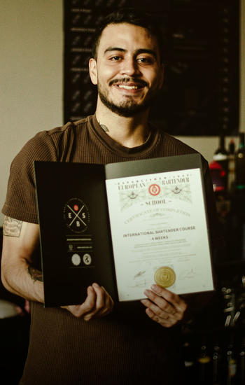 guy holding his certificate