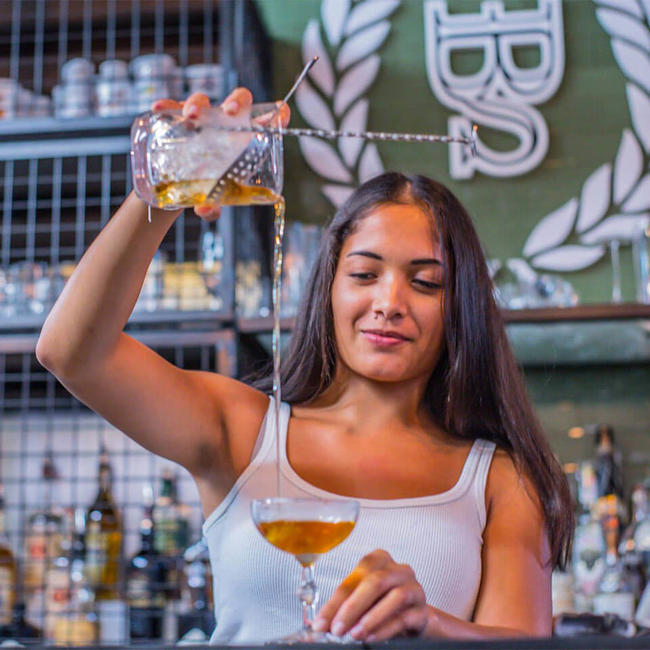 mexican girl pouring a cocktail